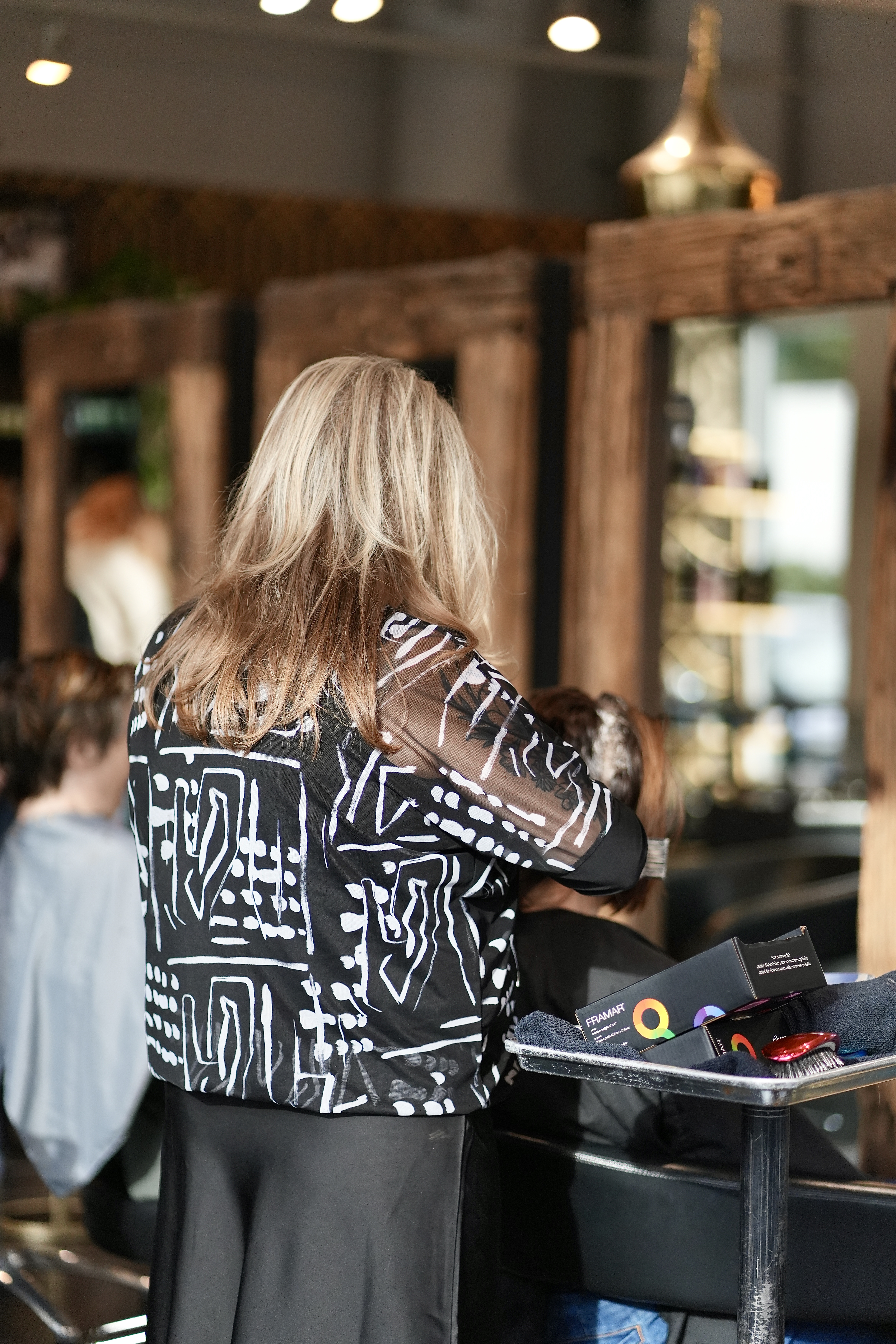 A stylist working with a guest at a well-organized station in the salon
