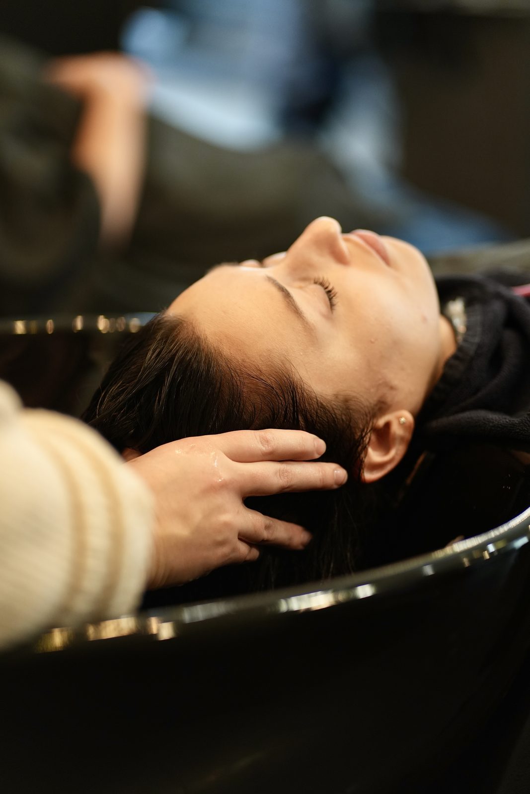 A cut in progress with wet, sectioned hair