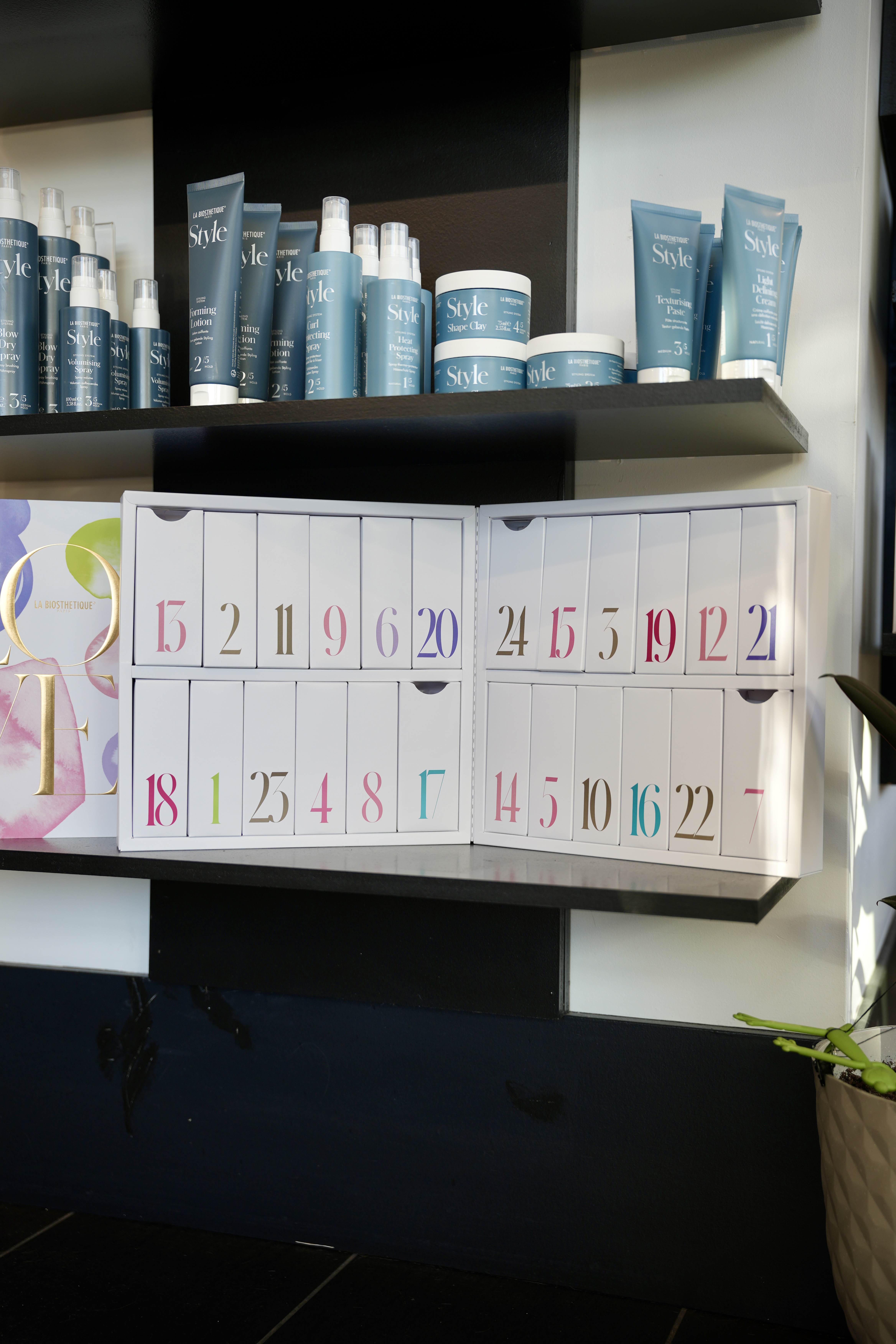 A styling display at Mod Salon with brushes, brand catalogs, and the styling collection