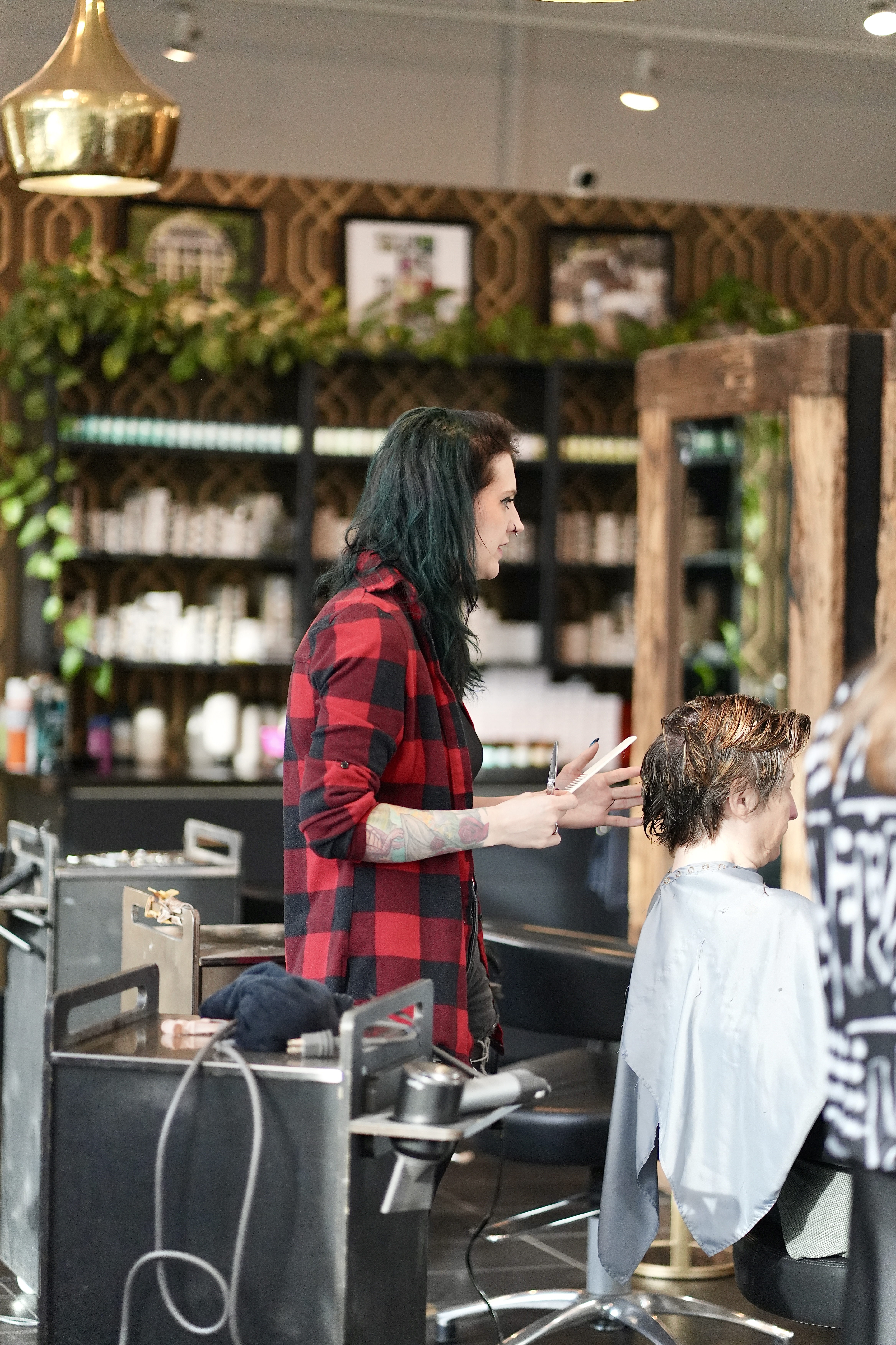A Mod Salon stylist mid-consultation with a guest in the cutting area